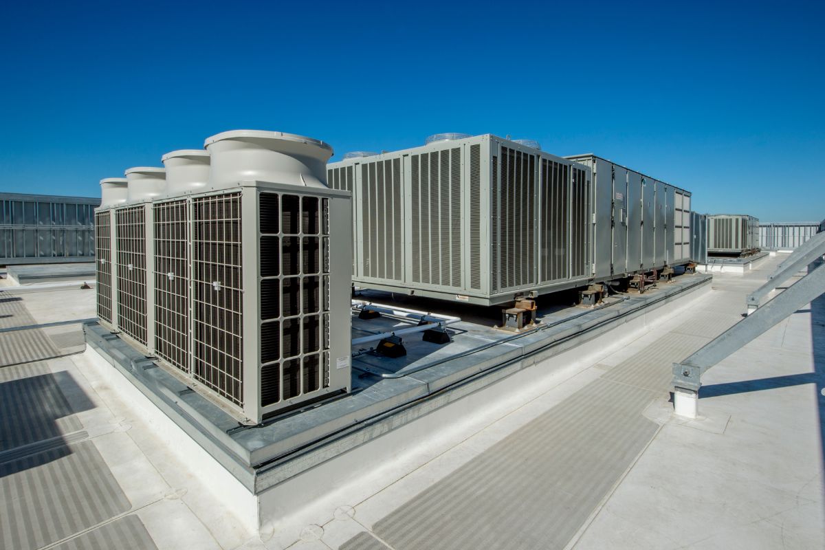 Air conditioning systems installed on a rooftop, highlighting potential mold issues in HVAC units.
